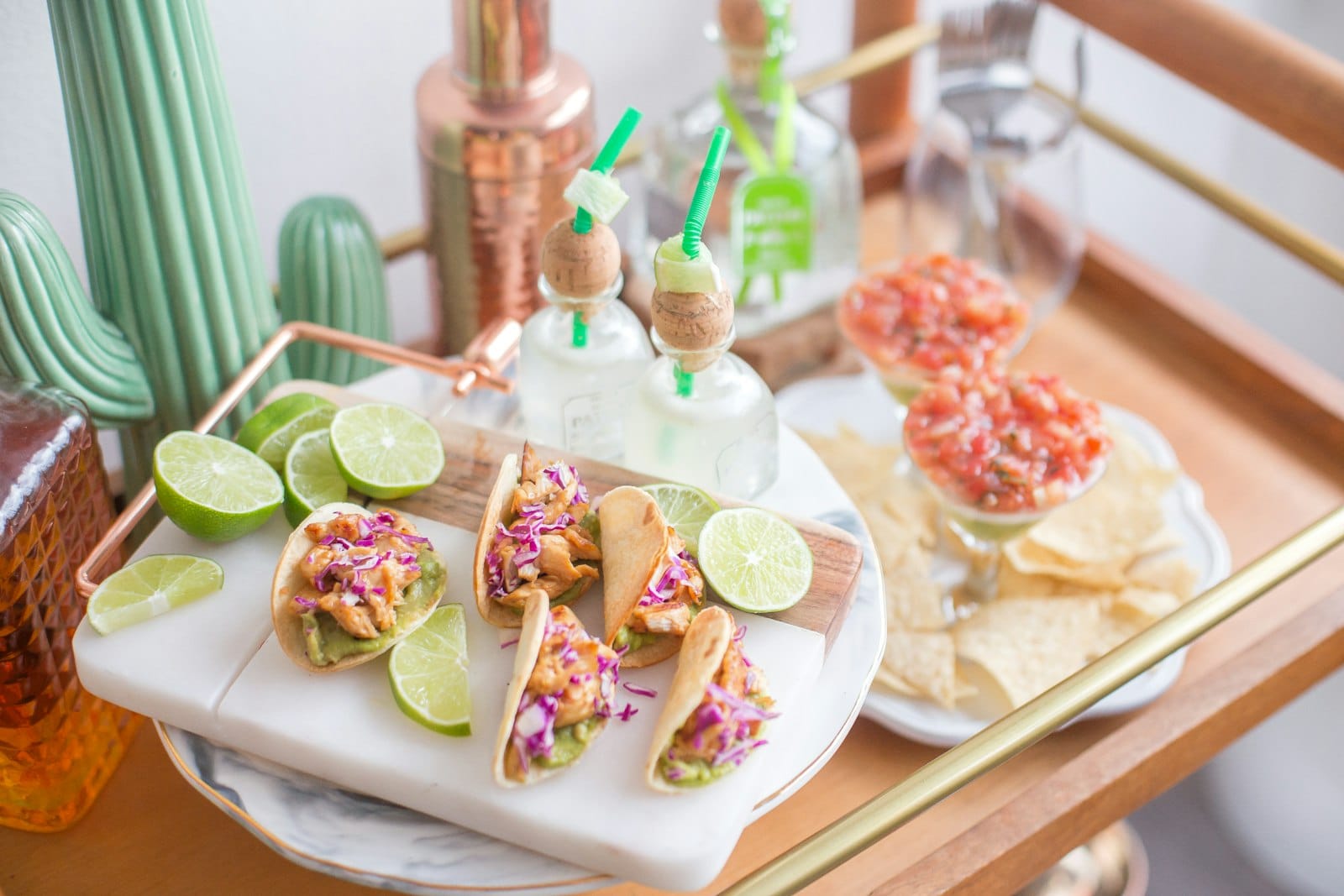 A taco display with drinks and salsas for Cinco de Mayo.