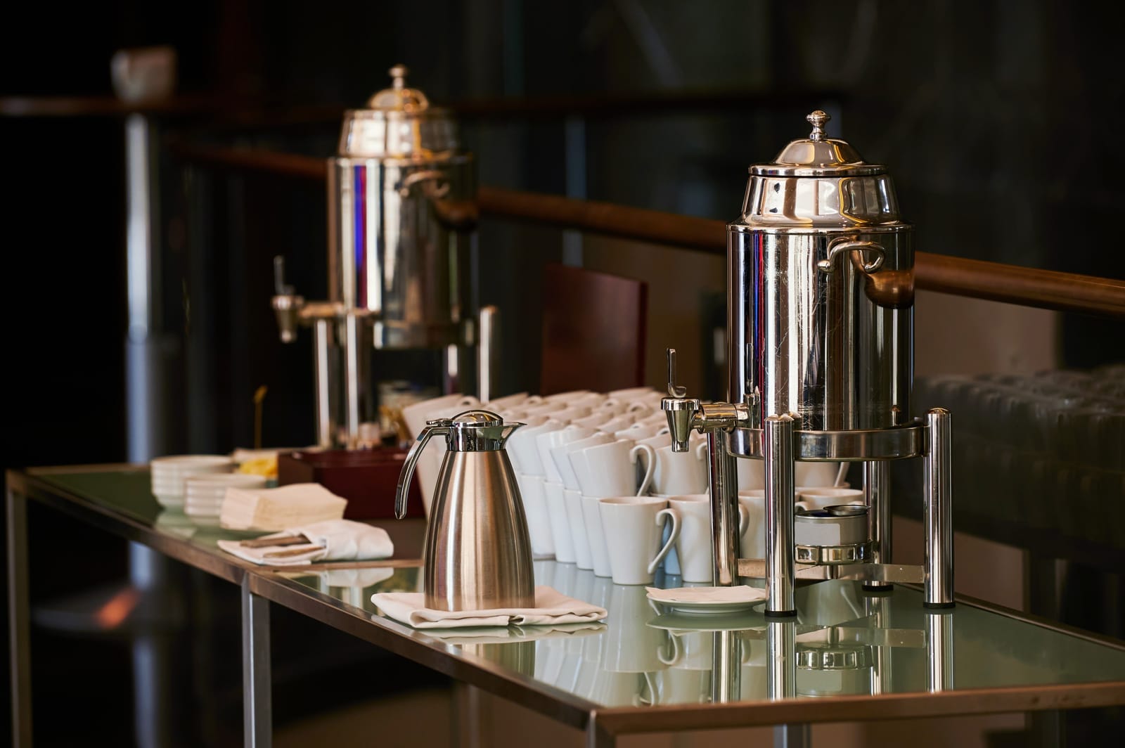 Catering coffee equipment with mugs and creamer for an event.