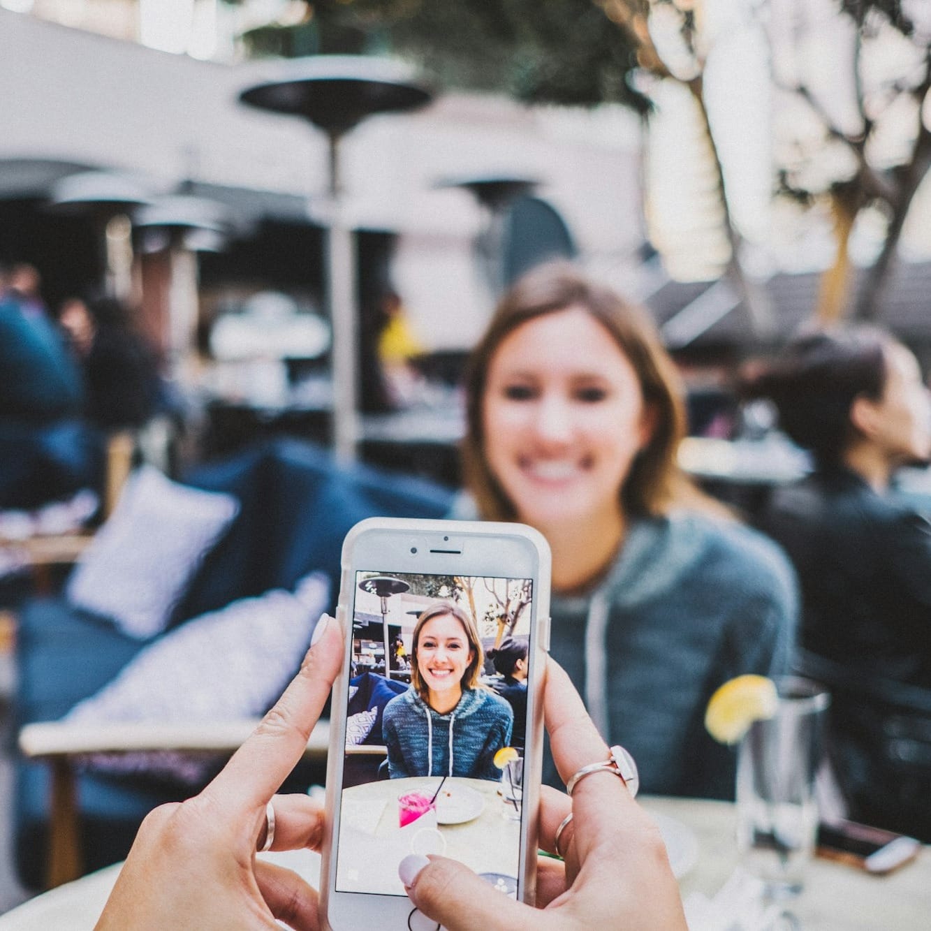 person taking photo of woman