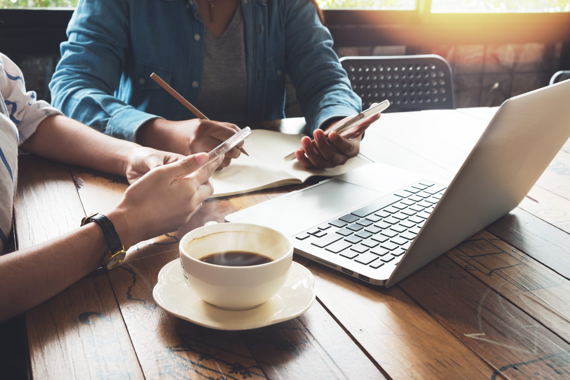 Two coffee shop business owners brainstorming new names for their coffee business.