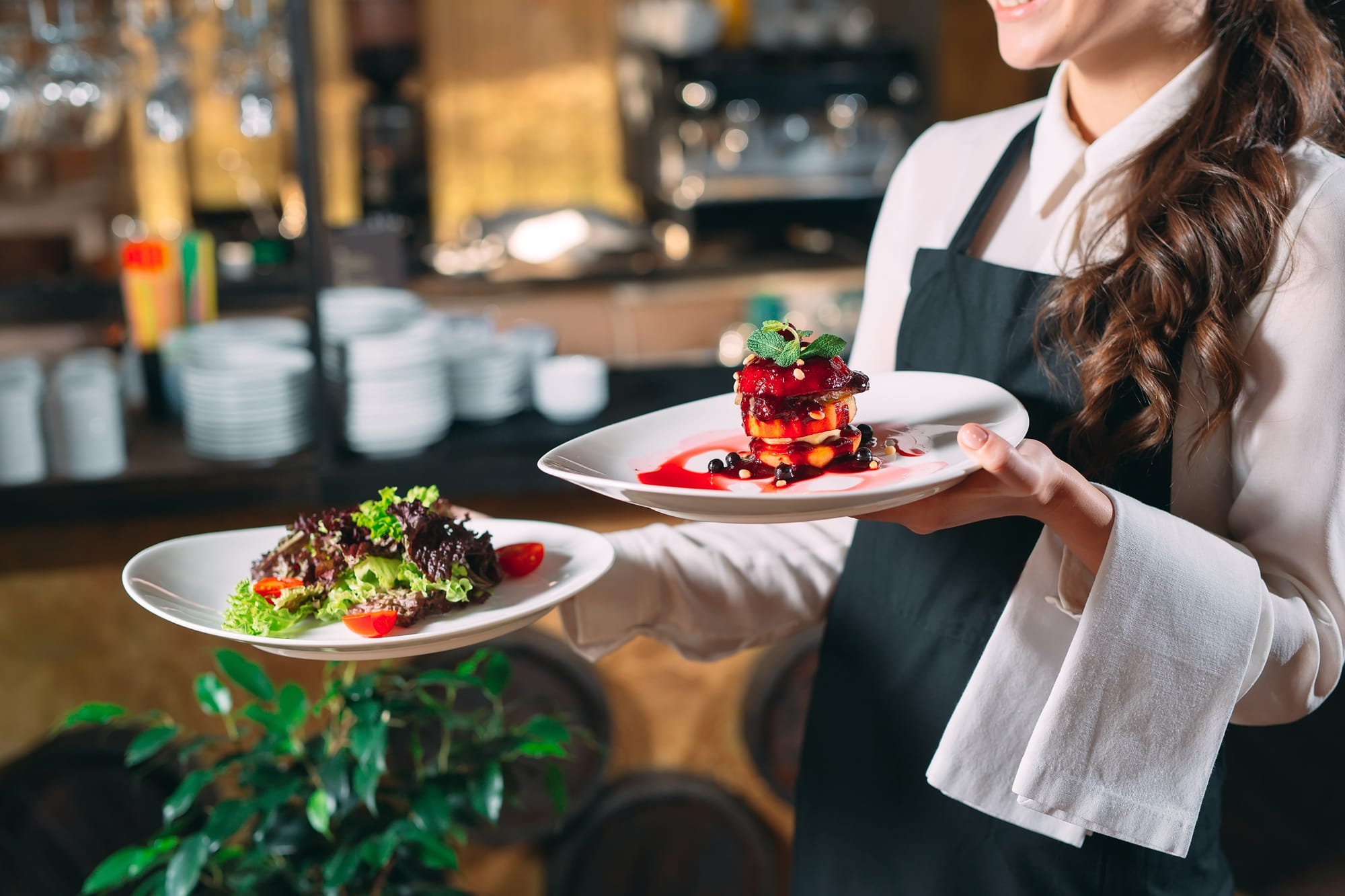Server taking entree's to a table.
