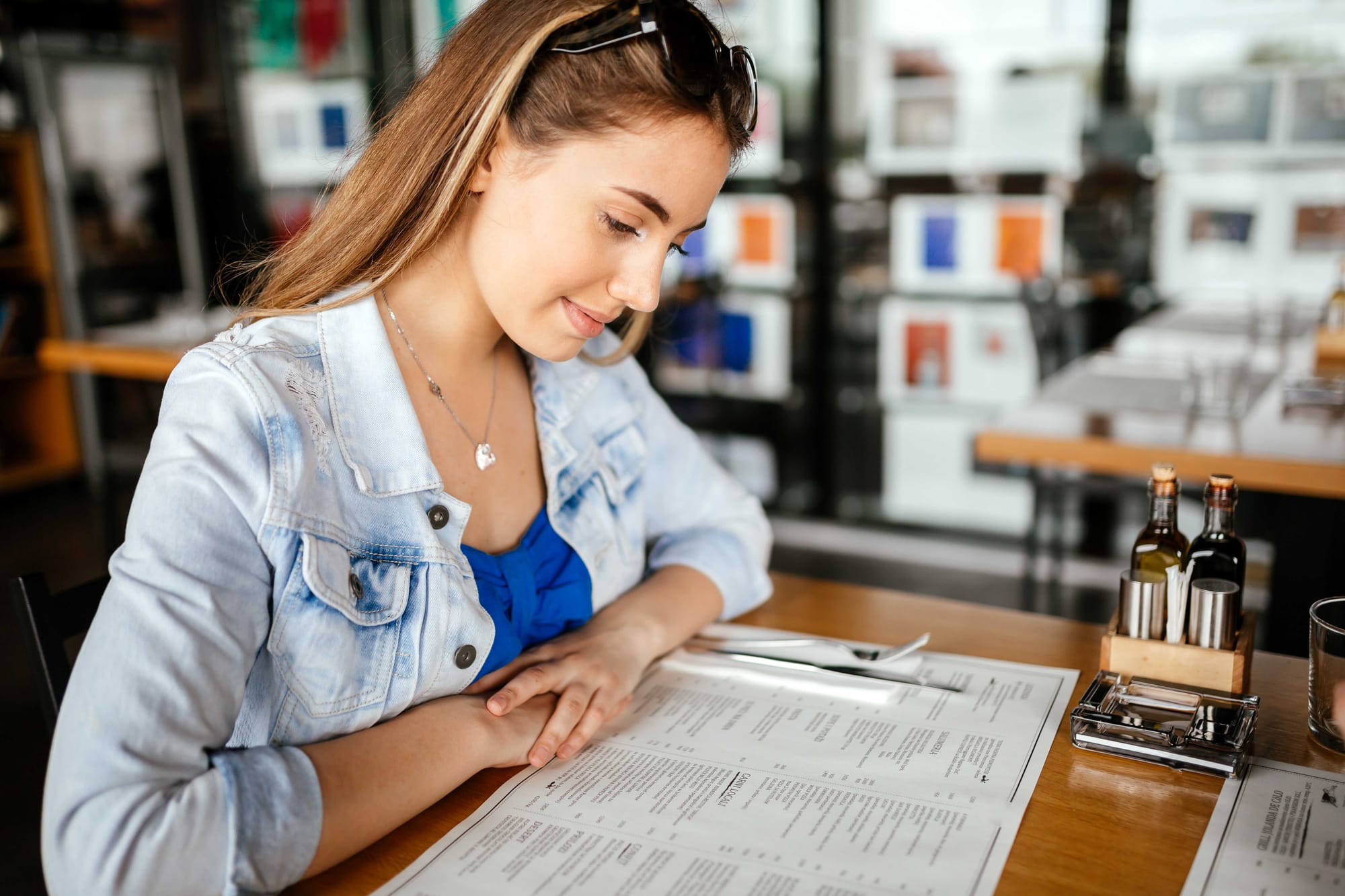 A restaurant guests looks at a menu on a table