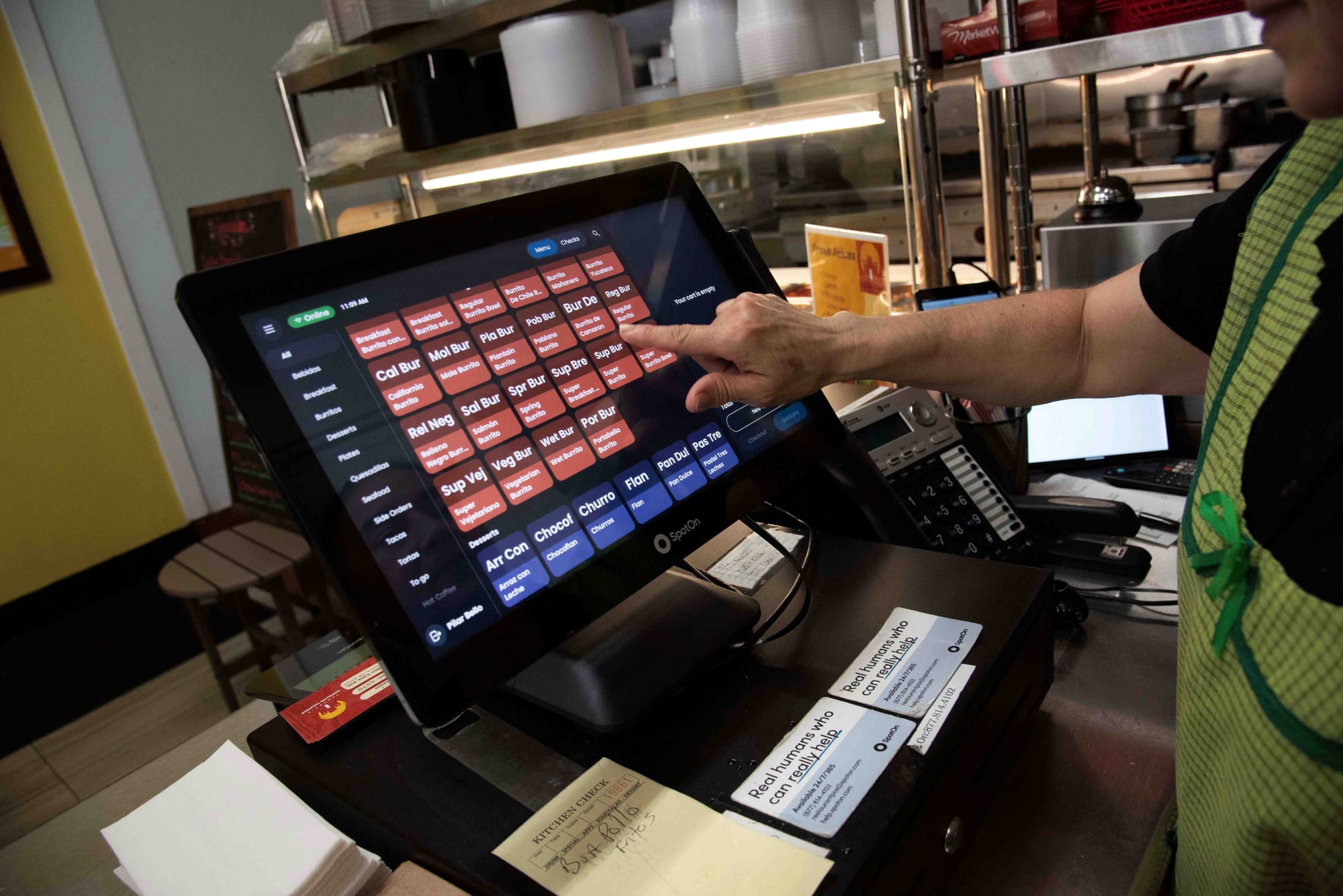 A SpotOn client taps in an order on their SpotOn POS