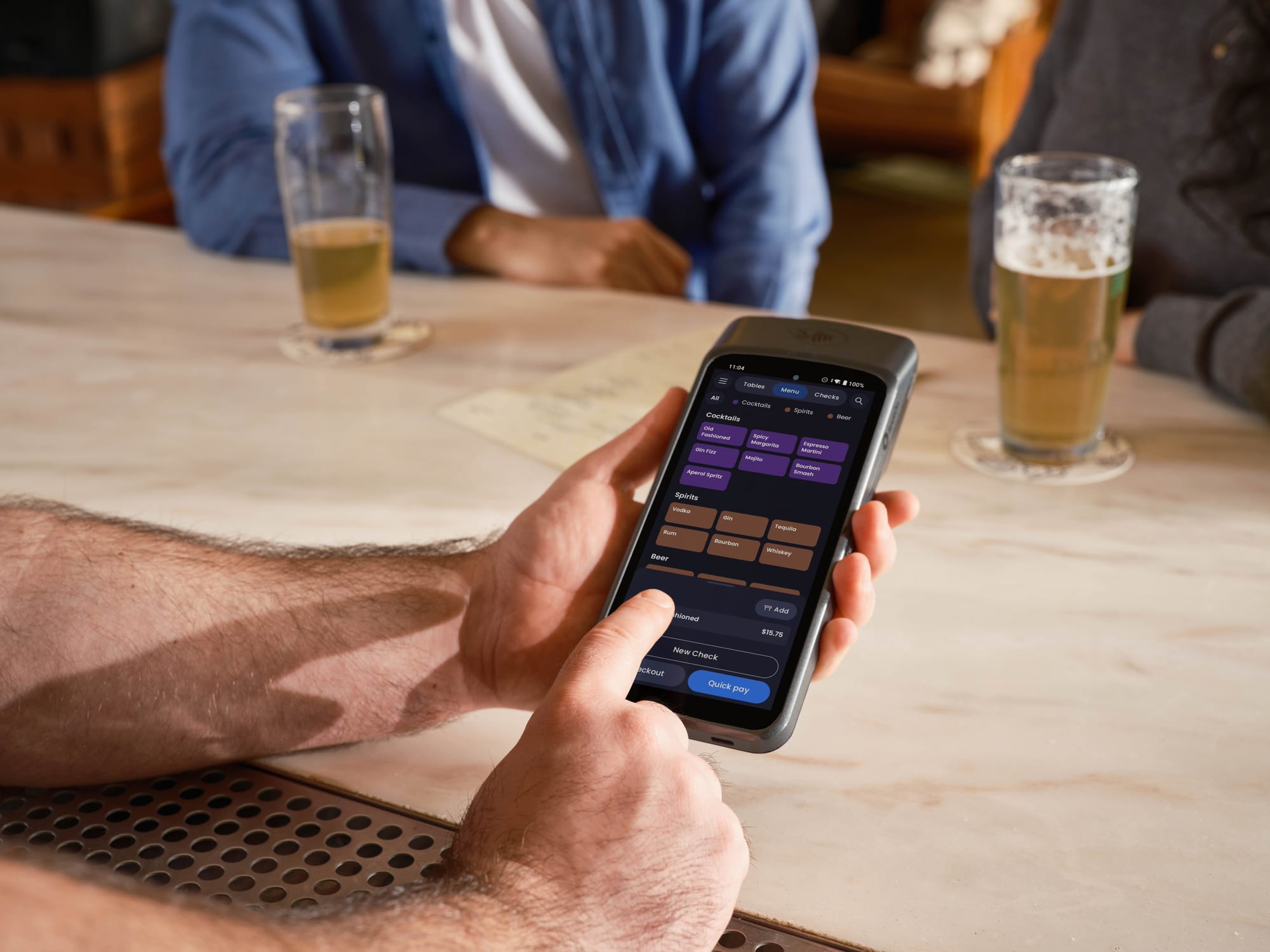 handheld POS adding second round drinks at restaurant patio table