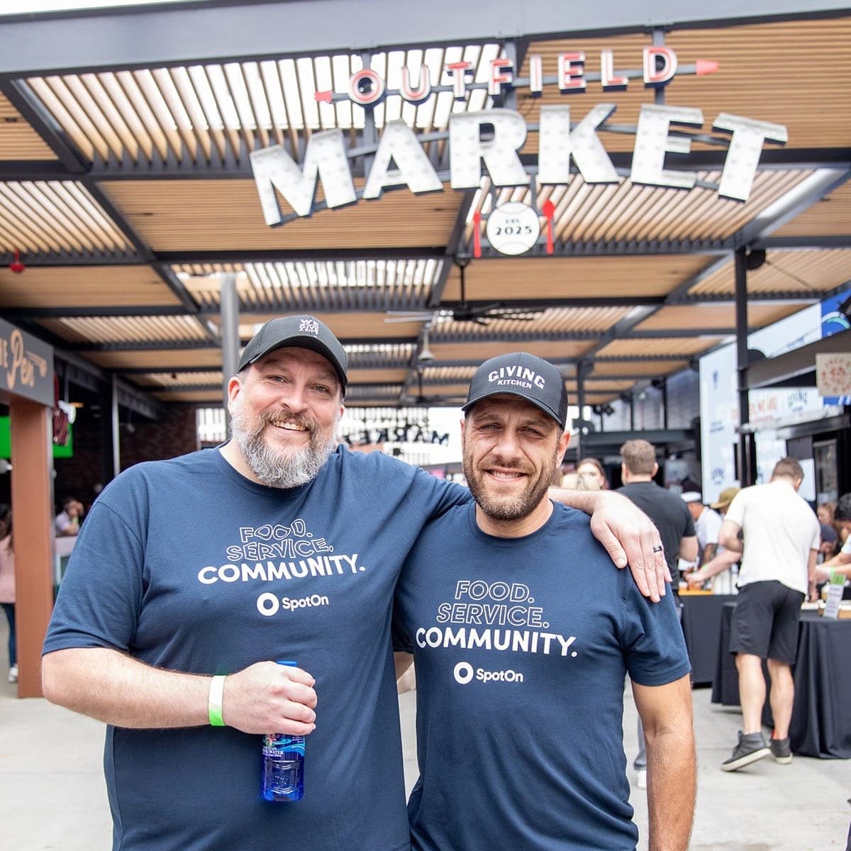 2 SpotOn employees pose for a photo at the Team Hidi event