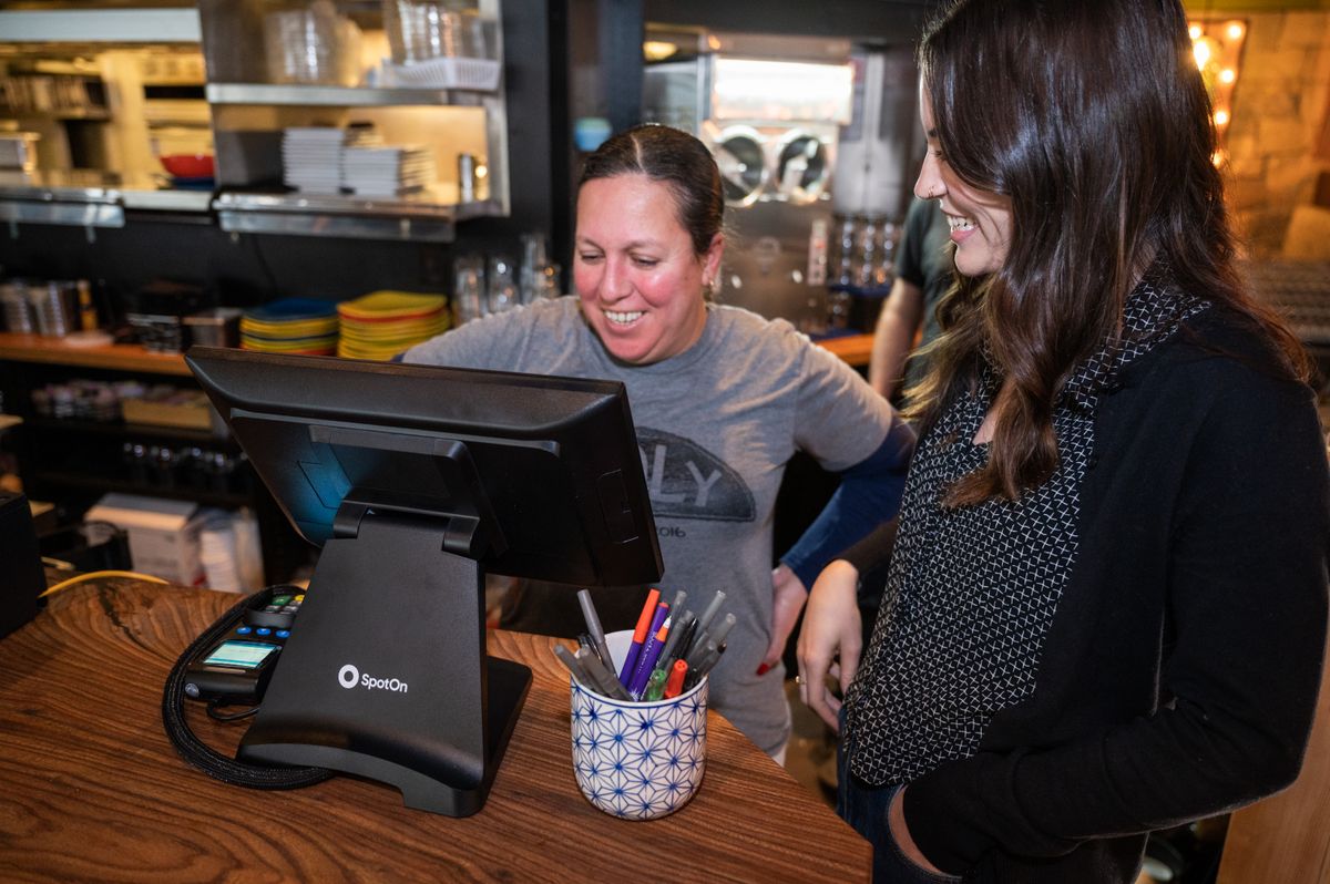 A Holy Taco employee and co-owner Hanna Lee check out their new SpotOn point-of-sale
