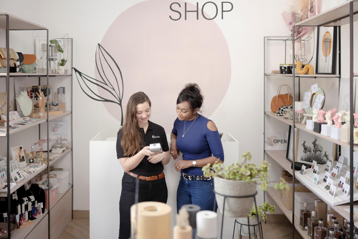 A local SpotOn representative helps a retail shop owner set up her new POS device to increase profits