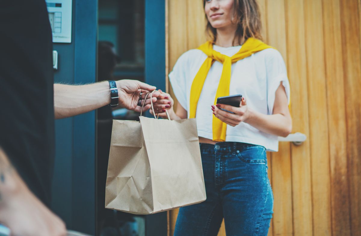 Woman picking up online ordering from a restaurant delivery app