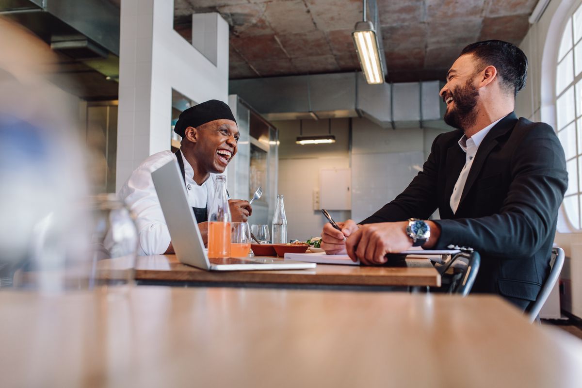 Restaurant manager meets with chef before a dinner service