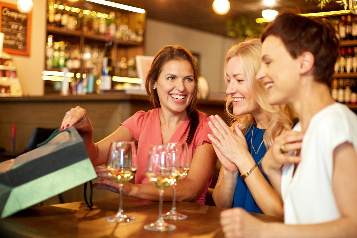 3 guests having glasses of wine at a restaurant