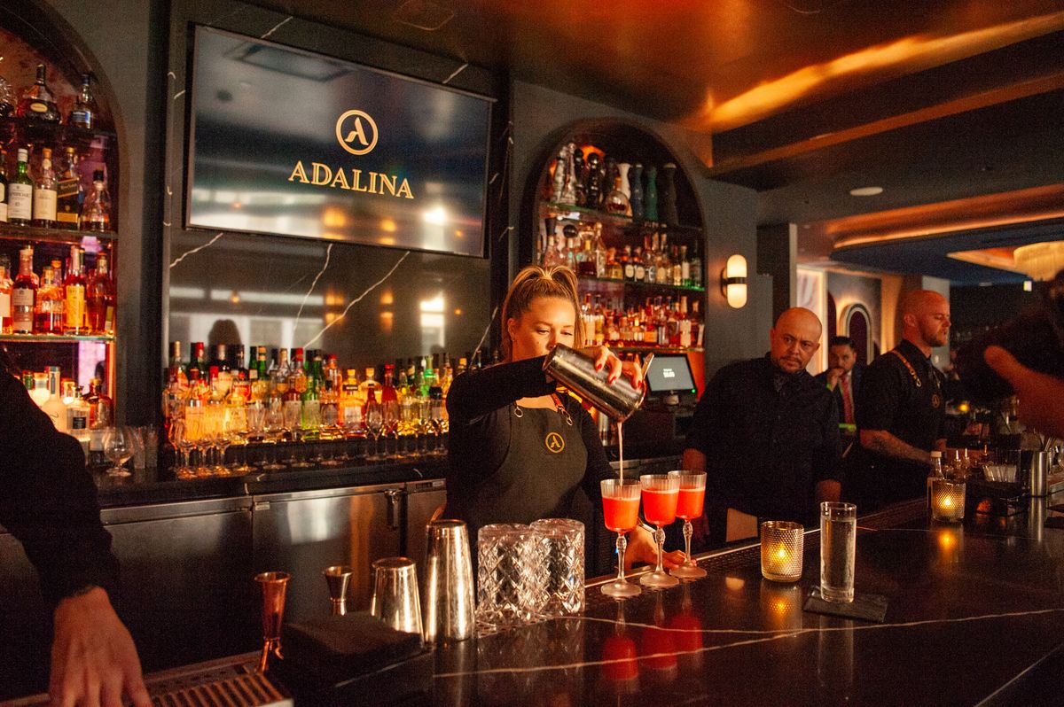 A bar tender pours a round of holiday drinks