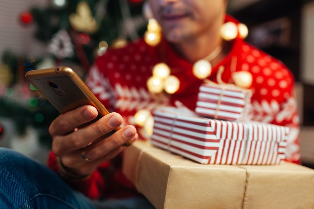 Holiday shopper scrolling on Instagram with Christmas gifts from online store shopping