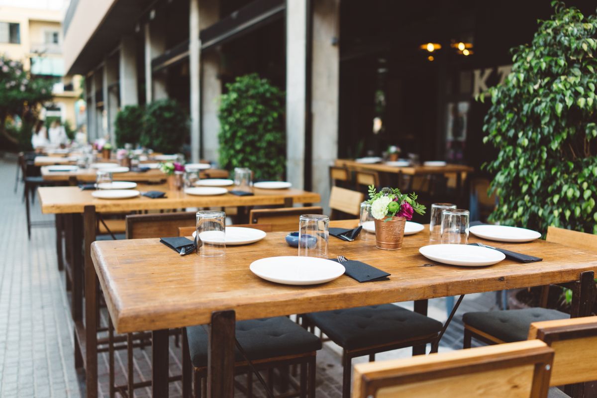 Restaurant waitlist template: Empty reservation table at a restaurant outdoor seating area for guests.