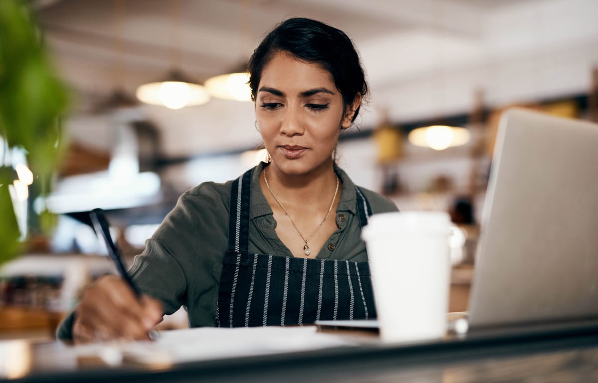 Restaurant owner calculating the costs of opening a restaurant.