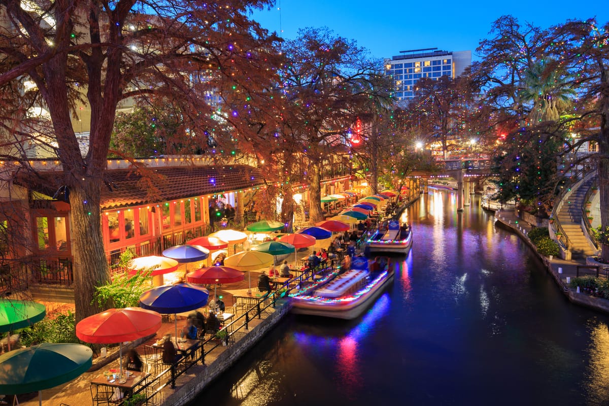 City river walk in Texas with restaurants and businesses and tourists