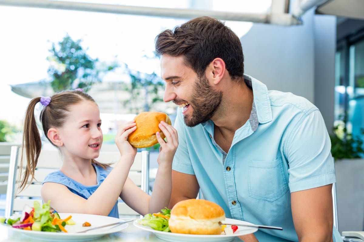 Father and daughter eating at a restaurant for Father's Day.