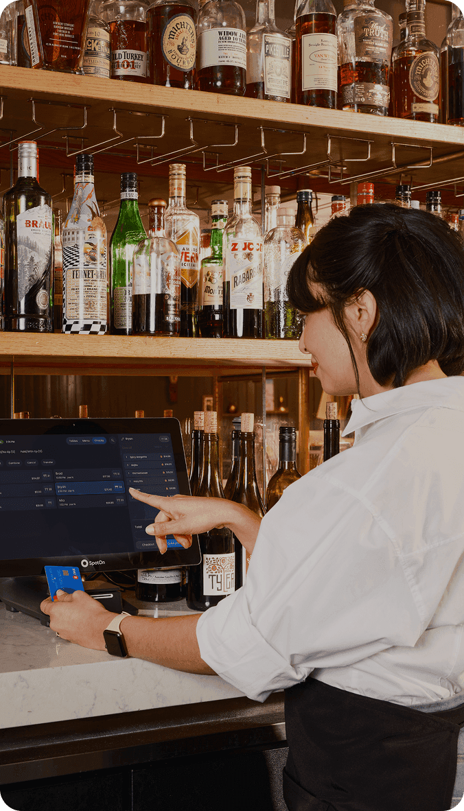 Bartender serving drinks at a busy pub