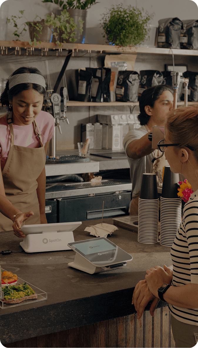Customer looking at pastries in a cafe display case