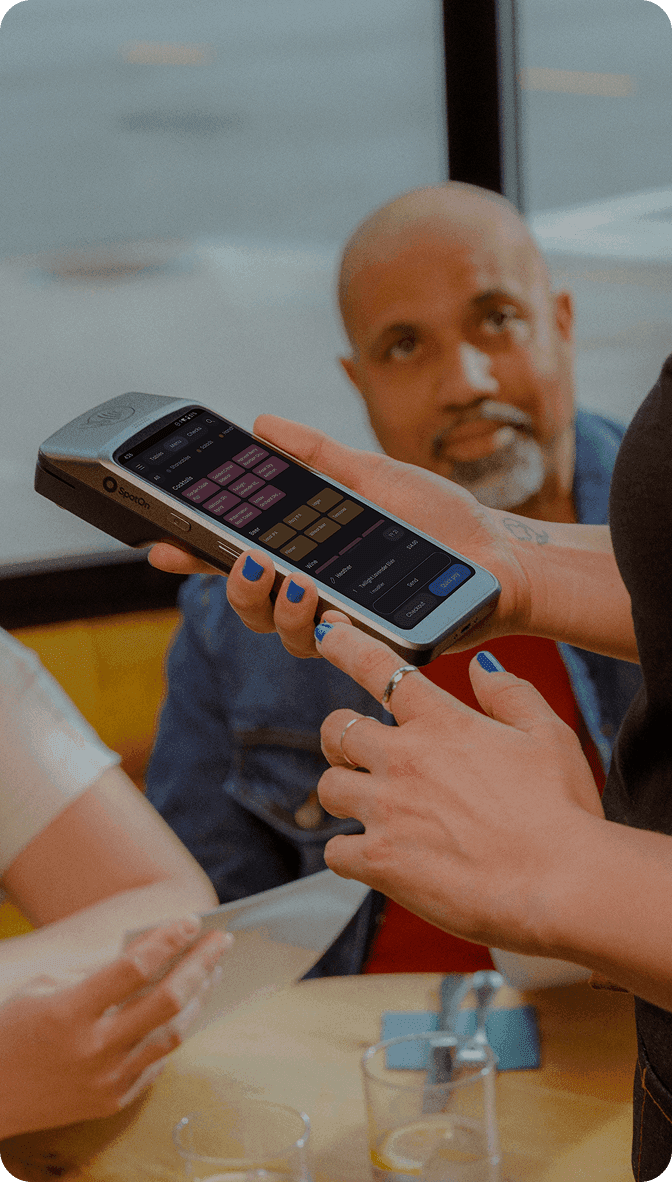 Server using SpotOn POS system in a casual dining restaurant