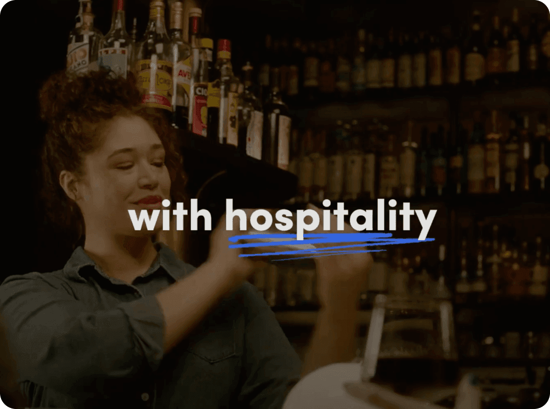Bar service environment with text overlay reading 'with hospitality' against backdrop of illuminated liquor bottle display