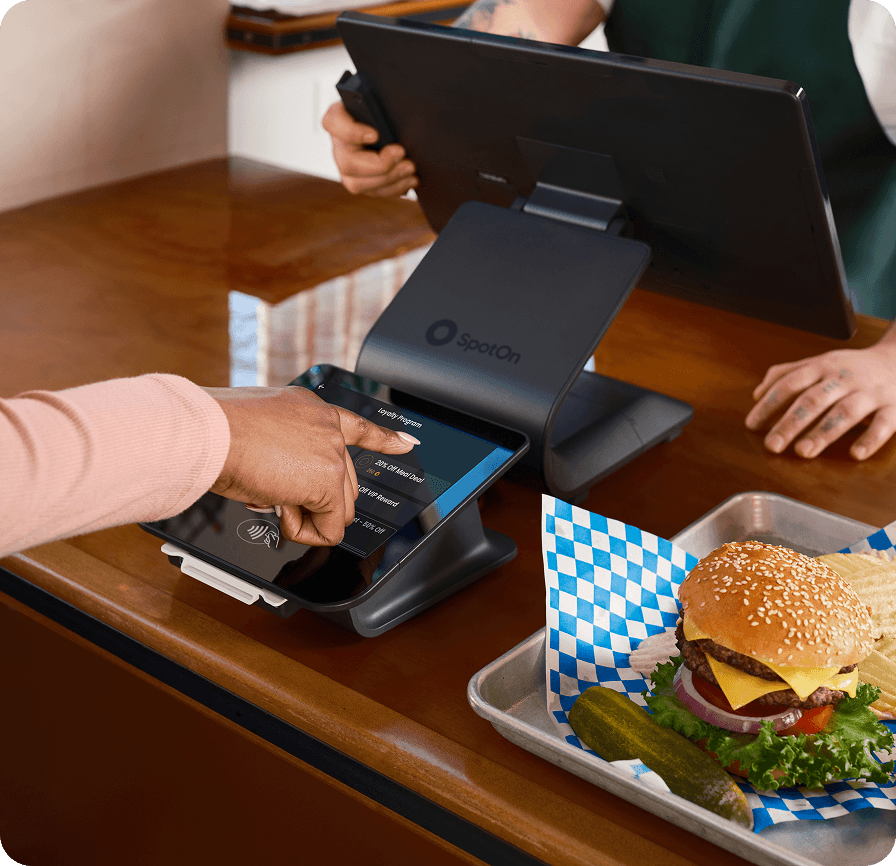 Couple using phone to redeem marketing deal while dining