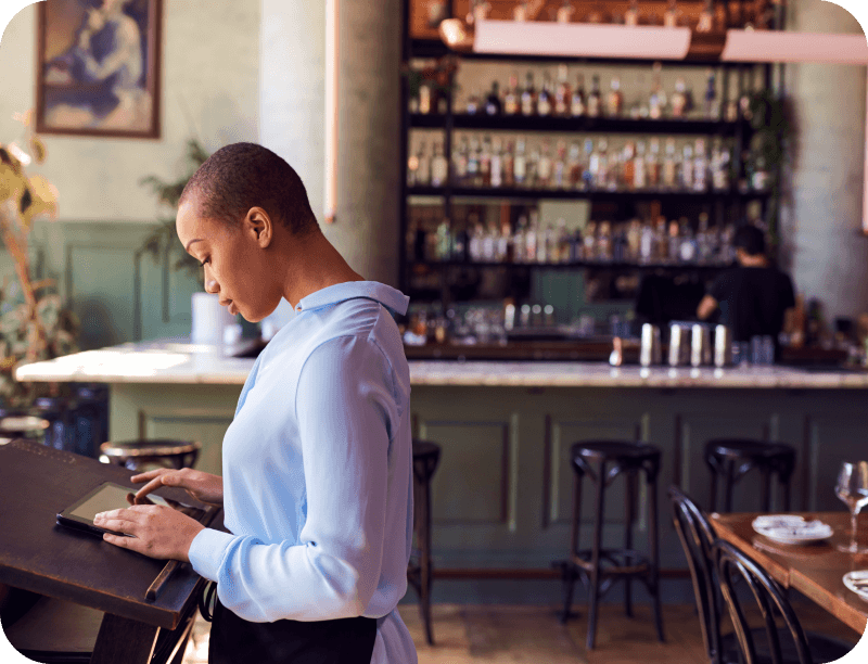 Restaurant customers check in for their reservation at the host stand