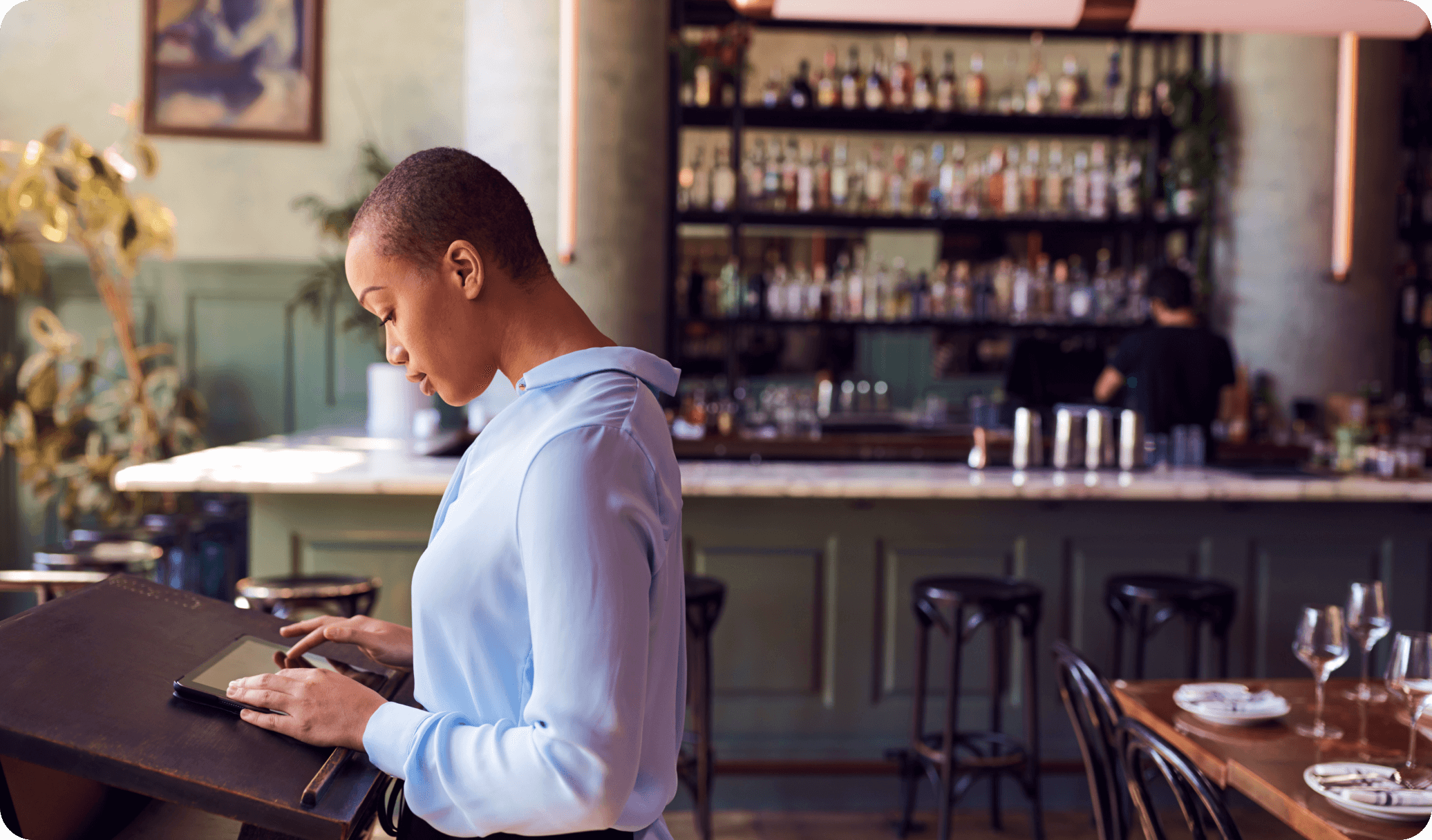 Restaurant customers check in for their reservation at the host stand