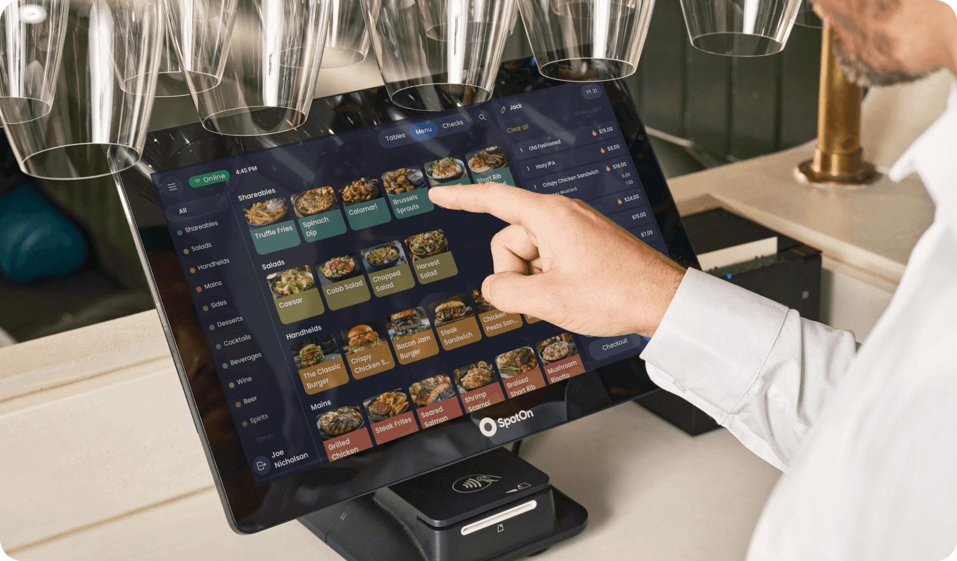 Server using SpotOn POS on Station 15 in a casual dining restaurant