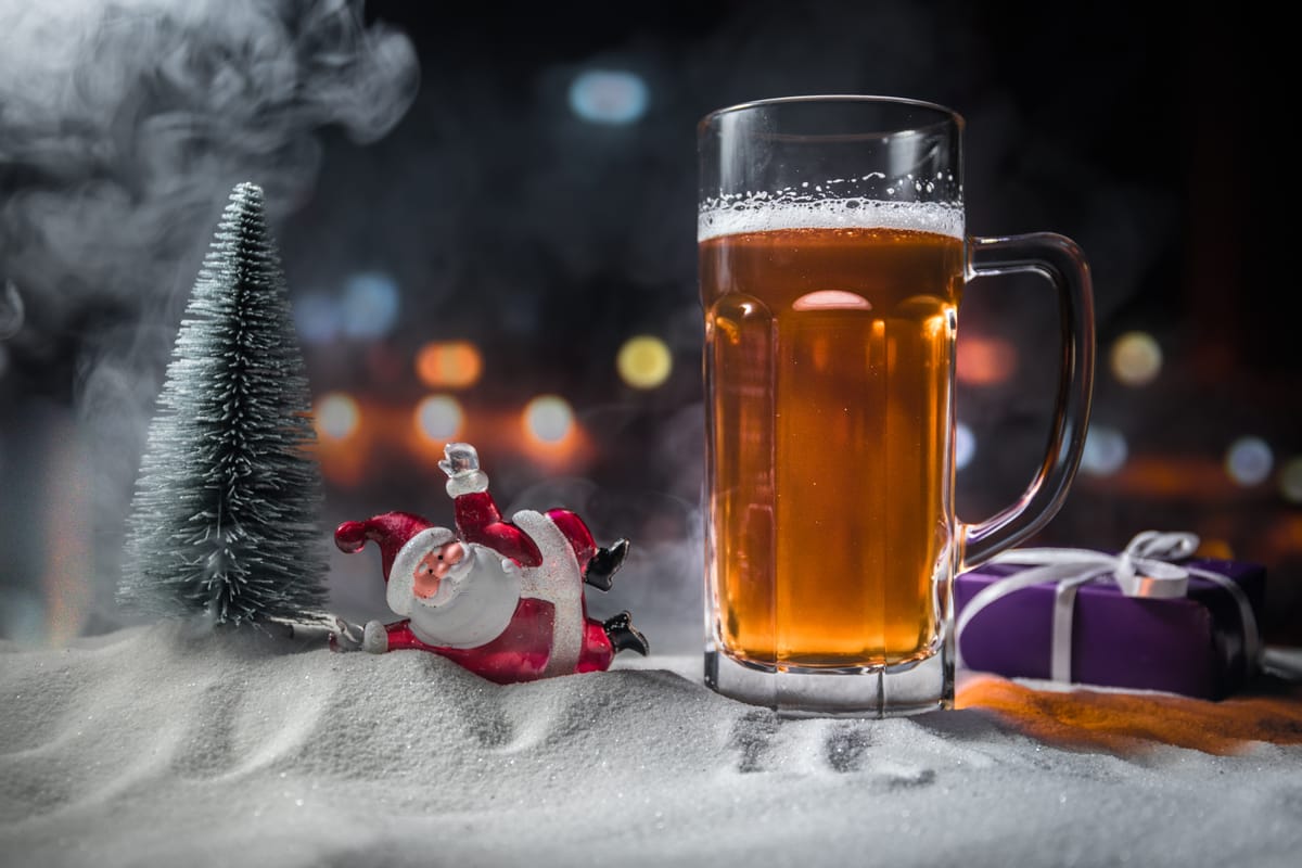 Holiday beer Christmas cocktail in a bar with Santa at the bar.