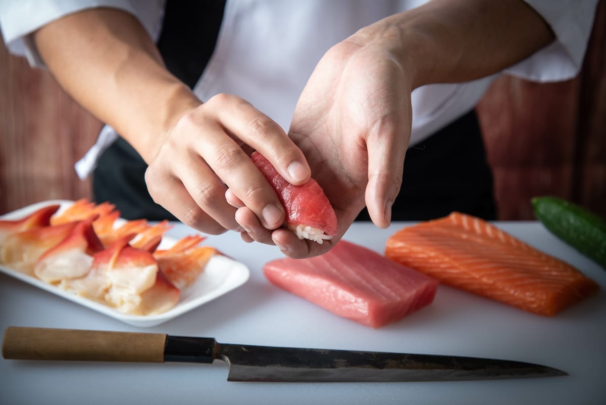 Slices of nigiri prepared by hand from a sushi chef.