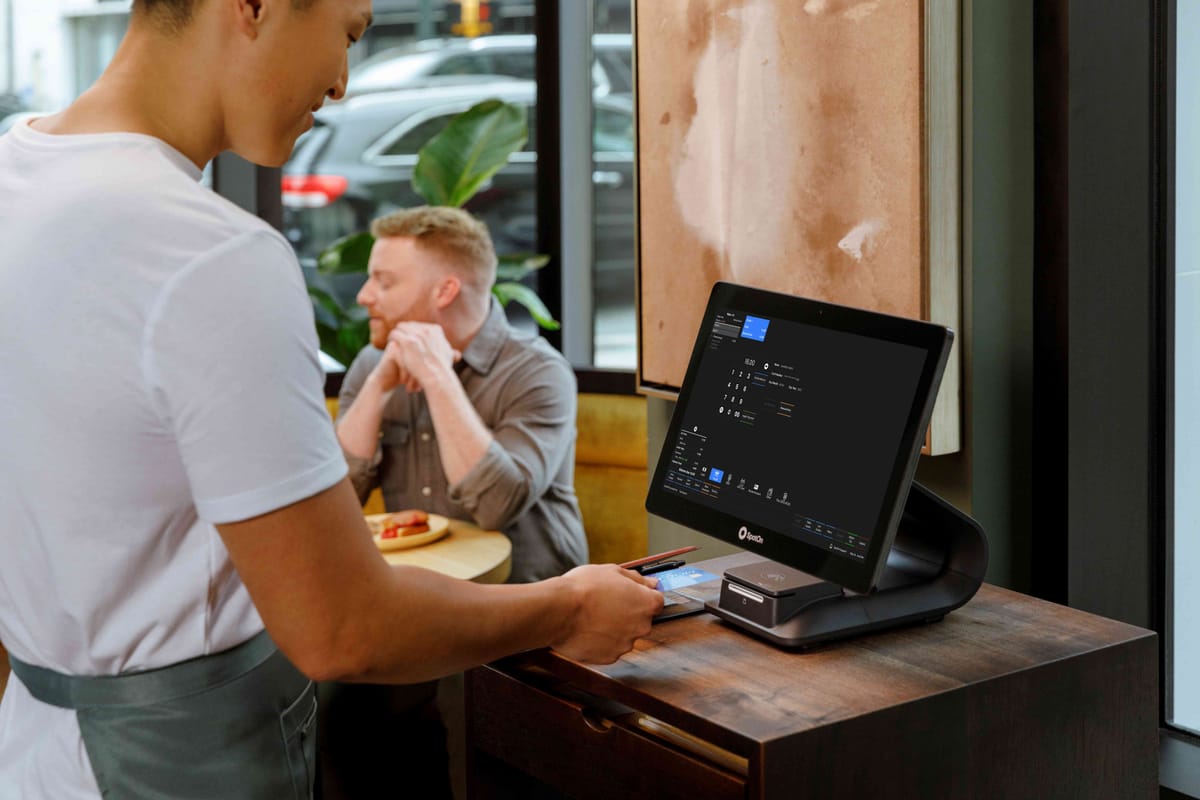 A server runs a payment on a restaurant POS from SpotOn, a Fast Company's Most Innovative Company list for 2024